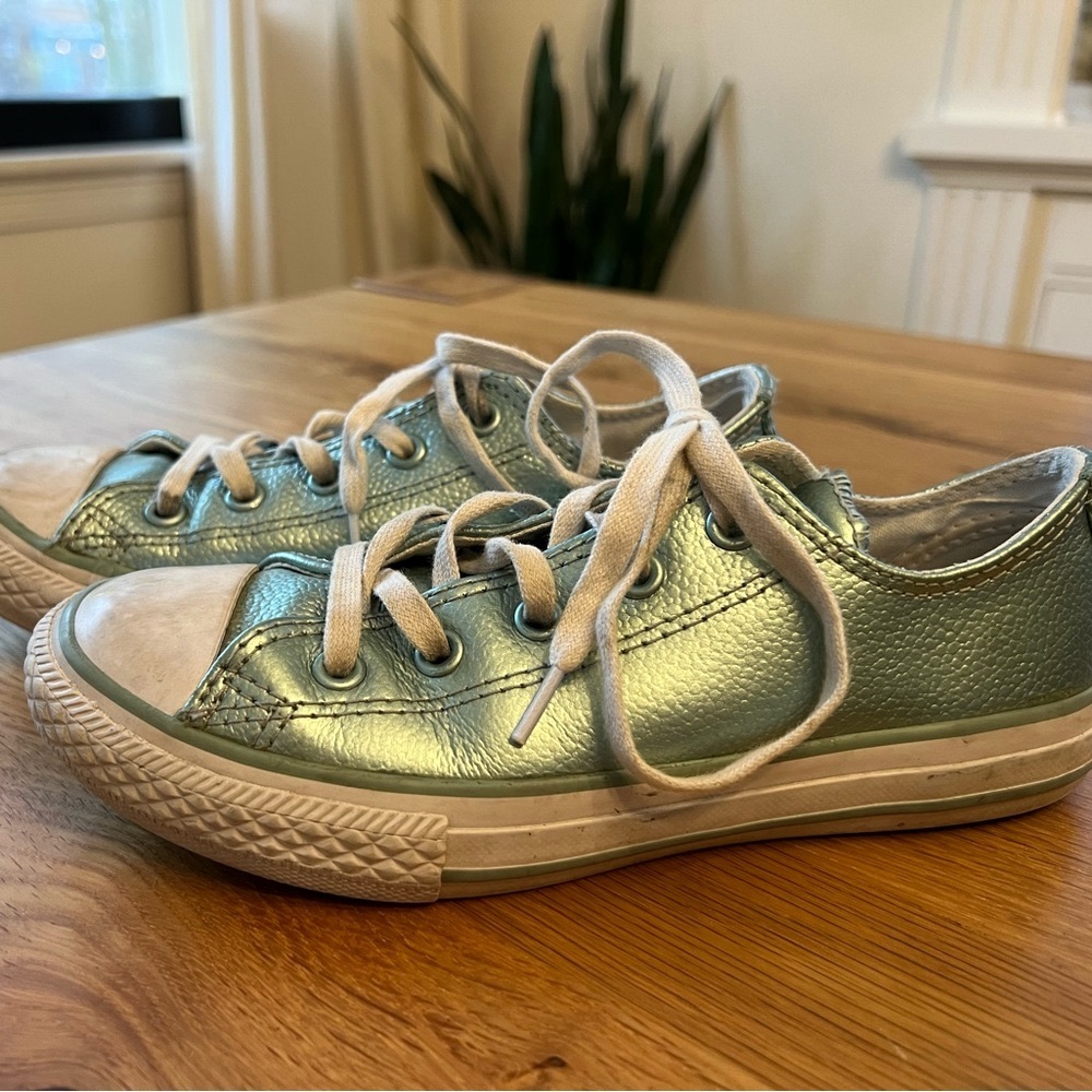 Shiny turquoise low-top Converse.